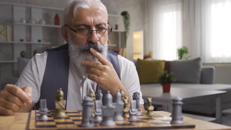 Mature-man-playing-chess-and-developing-his-strategies.